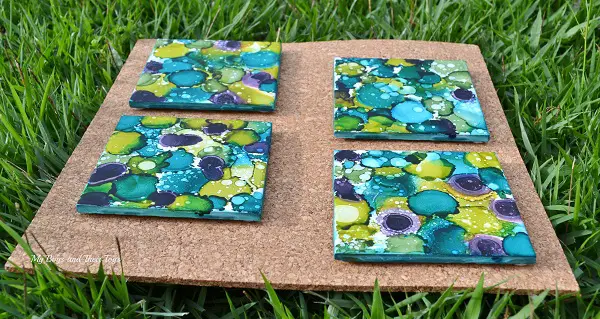 alcohol ink dyed coasters in grass