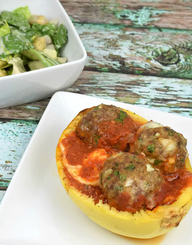 spaghetti squash boats with cheese stuffed meatballs and side salad