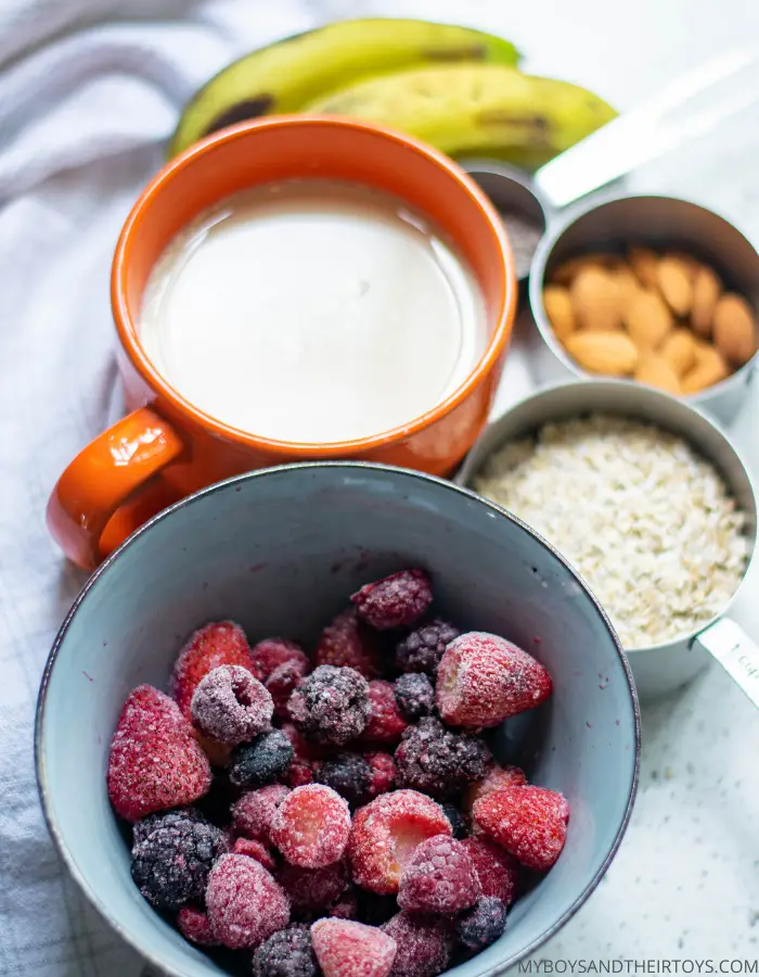 mixed berry oats ingredients, frozen berries, milk, oats, almonds